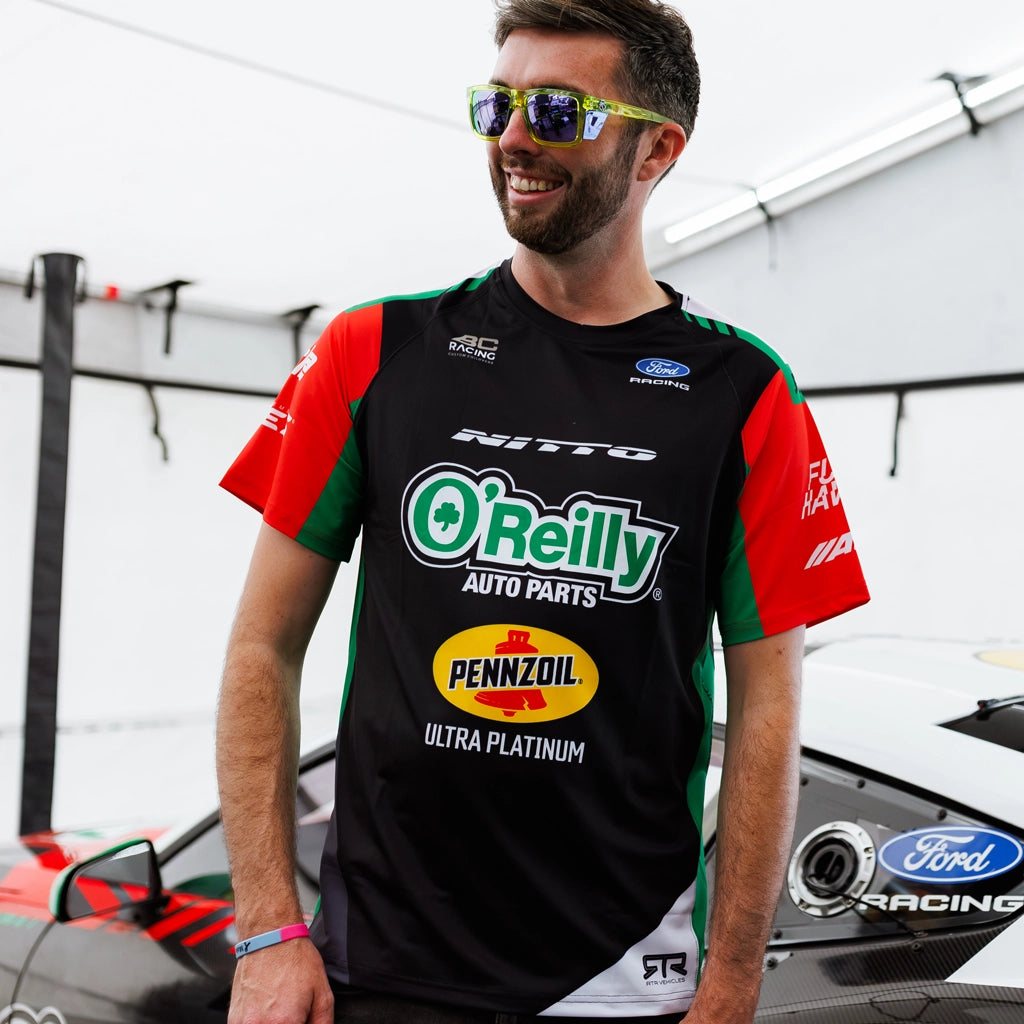 James Deane wearing his 2026 RTR Drift Team Sublimated Shirt in the RTR garage pits at Formula Drift.