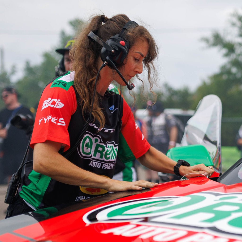 RTR Vehicles crew member wearing the James Deane 2026 RTR Drift Team Sublimated Shirt working on James Deane's race car at a Formula Drift event.