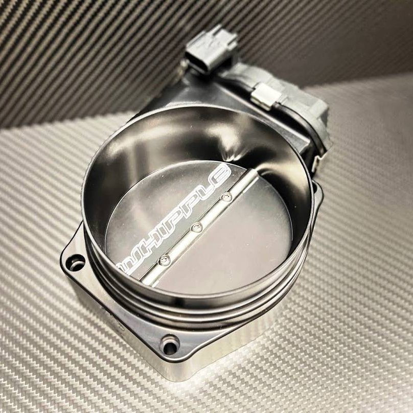 Whipple Supercharger Stage 2 Upgrade Kit for 2024+ Mustang, featuring a visible electronic throttle-body assembly and butterfly plate, enhancing performance with improved airflow and efficiency.